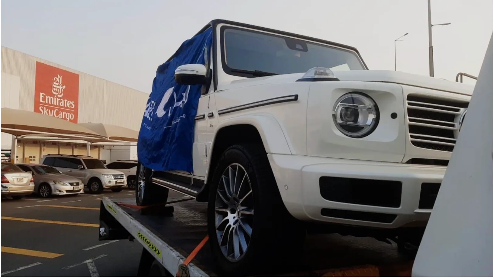 Vehicle loaded on a flatbed at an air cargo terminal